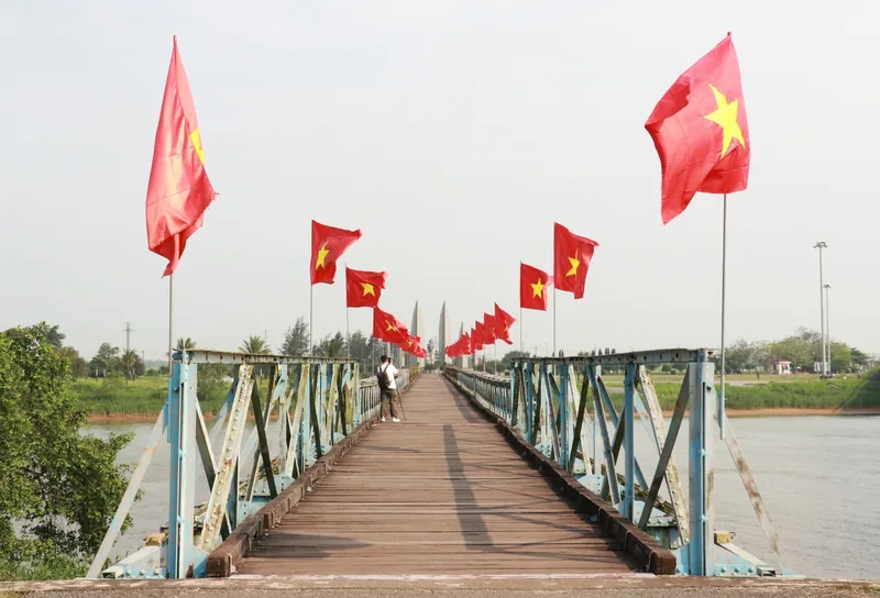 Cờ Tổ quốc tung bay dọc cầu Hiền Lương bắc qua sông Bến Hải ở Quảng Trị.